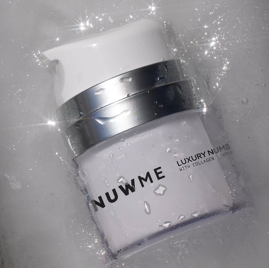 NUWME luxury numbing cream jar in ice, highlighting cooling effect and premium skincare.